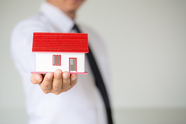 Businessman Holding Model House